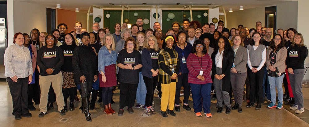 A group photo of URA staff smiling