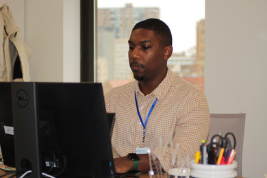 Marcus Robinson sits at his desk, working.